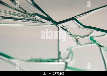 Broken glass pile pieces of texture and background isolated on white, cracked window effect. Emergency condition Stock Photo