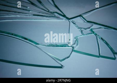 Broken glass pile pieces of texture and background isolated on white, cracked window effect. Emergency condition Stock Photo