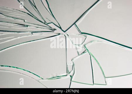 Broken glass pile pieces of texture and background isolated on white, cracked window effect. Emergency condition Stock Photo