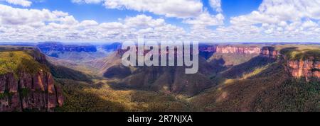 Deep wide canyon in BLue Mountains of Australia from Govetts leap to Bridal Veil Waterfall in aerial panorama. Stock Photo