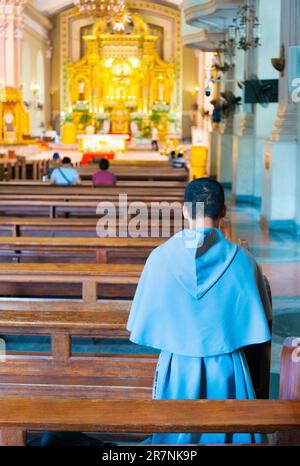 Cebu City,Cebu,Philippines-January 17 2023:During the day,faithful Filipino Catholics visiting the Cathedral,come and go,on a regular basis,to pray,me Stock Photo