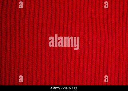 Pattern of colorful knitted sweaters closeup. Handmade merino wool product. Knitting patterns Stock Photo