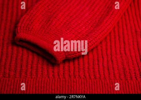 Pattern of colorful knitted sweaters closeup. Handmade merino wool product. Knitting patterns Stock Photo