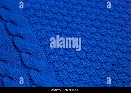 Pattern of colorful knitted sweaters closeup. Handmade merino wool product. Knitting patterns Stock Photo
