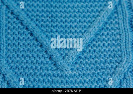 Pattern of colorful knitted sweaters closeup. Handmade merino wool product. Knitting patterns Stock Photo