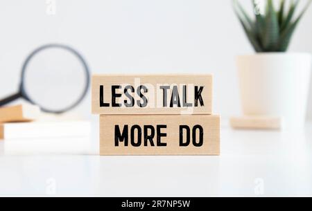 Less Talk more Do, written on a sticky note Stock Photo