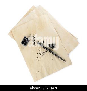 Parchment with stains of ink, fountain pen and inkwell on white background, top view Stock Photo