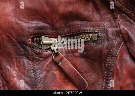 leather red background with zipper on it close up Stock Photo