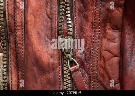 leather red background with zipper on it close up Stock Photo
