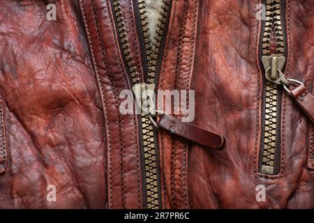 leather red background with zipper on it close up Stock Photo