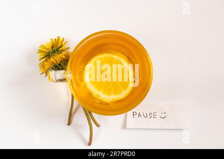 a cup of tea with lemon dandelions and the words in English good morning Stock Photo