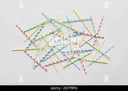 Different paper drinking straws on blue background Stock Photo