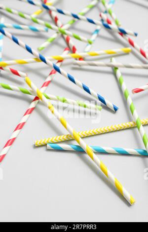 Different paper drinking straws on blue background Stock Photo