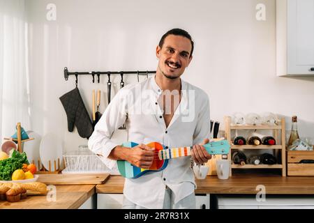 Happy man enjoying with music playing on instrument Stock Photo