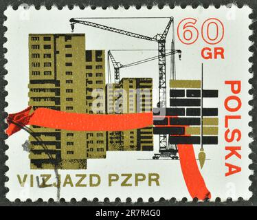 Cancelled postage stamp printed by Poland, that shows  Apartment Houses under Construction, 6th Congress Of The Polish United Worker's Party, circa 19 Stock Photo