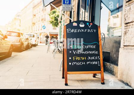 Street menu next to cafe. Exterior coffee shop. Stock Photo