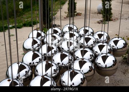 triangular metal large newton balls in a garden. Stock Photo
