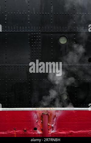 LONG BEACH, CALIFORNIA - 14 JUN 2023: Steam rising from a pipe on the hull of the Queen Mary Hotel. Stock Photo
