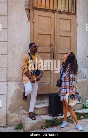 A beautiful multiracial friends are standing in front of an old building Stock Photo