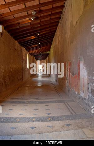 Corridor passageway with mosaic tile floor  in a house at Roman town of Herculaneum,  buried in the Vesuvius eruption in AD79. Ercolano, Naples, Italy Stock Photo