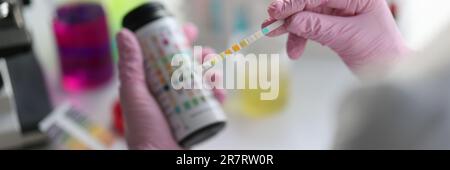 Chemist scientist holding ph test in hands closeup. Analysis in laboratory concept Stock Photo