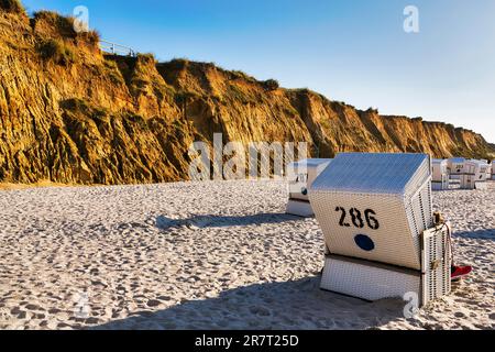 White beach chairs, Red Cliff in the evening light, Sylt, Germany Stock Photo