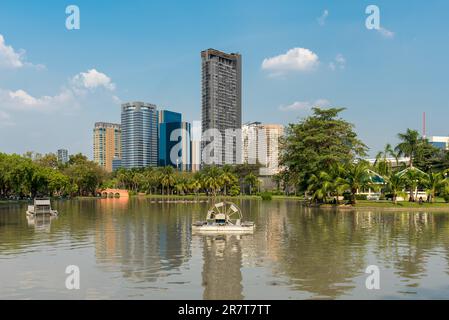 The Chatuchak park is one of the oldest public parks in Bangkok. An artificial lake runs along this thin and long park with numerous bridges crossing Stock Photo