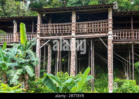 Orang Ulu longhouse in Sarawak on the Santubong peninsula in the Malaysian state of Sarawak in Borneo. Typical elaborately decorated with murals and Stock Photo