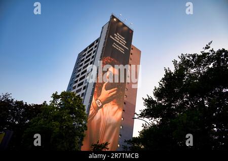 Huge advertising poster, banner, poster of Apple iPhone and Telekom as joint advertising on the outside facade of a high-rise building in Stock Photo