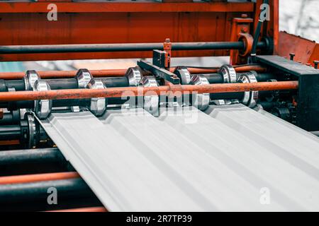 Metal Sheet Corrugated Forming Machine Production Line in Metal Panel Factory. Stock Photo