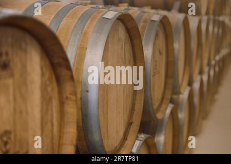 Wine fermentation barrels in wine cellar traditional winery making process for good taste and aroma of oak wood. Stock Photo