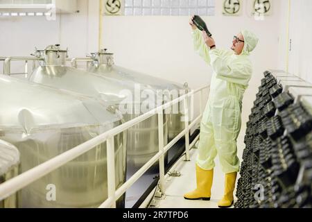 Wine making fermentation bottle Riddling or Disgorging process in wine factory. Stock Photo