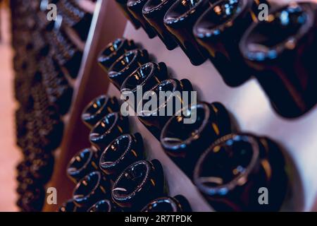 Wine making bottle resting for second fermentation Riddling Disgorging process in wine factory. Stock Photo