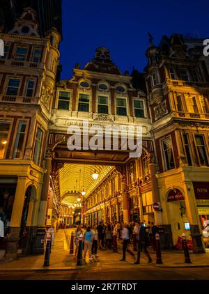 London, UK: The old Leadenhall market in the City of London at night. People enjoy a drink outside the New Moon pub. Stock Photo
