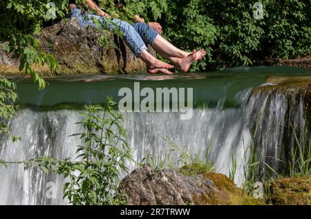 Munich, Germany. 17th June, 2023. People enjoy cooling off at the Eisbach in the English Garden, located in the heart of the Bavarian capital. Credit: Peter Kneffel/dpa/Alamy Live News Stock Photo