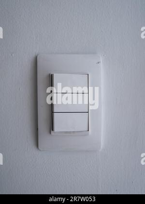 White Light Switch off on a Dirty White Wall Stock Photo