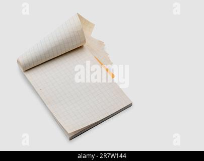 Vintage paper notepad with the squared pages open ready for notes. Isolated on white with clipping path included Stock Photo