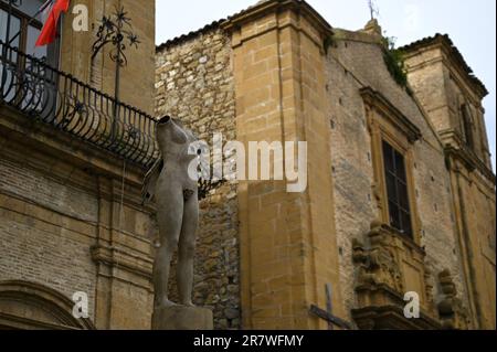 Antique stone sculpture on the exterior of the late Baroque style Palazzo di Città a historic landmark and cultural center of Piazza Armerina Sicily. Stock Photo