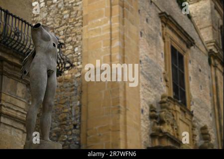 Antique stone sculpture on the exterior of the late Baroque style Palazzo di Città a historic landmark and cultural center of Piazza Armerina Sicily. Stock Photo