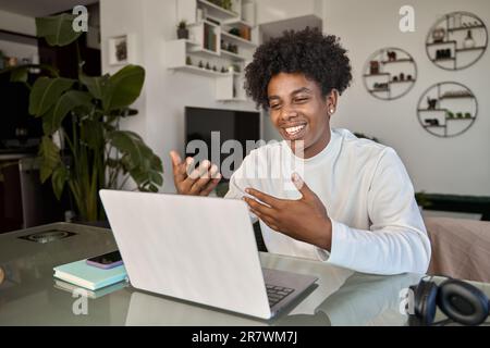 Young African guy student elearning or having remote hybrid meeting at home. Stock Photo