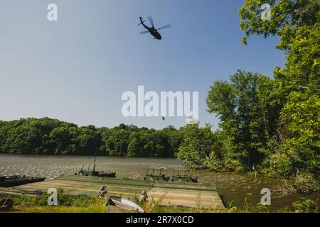 A member of the Indiana Helicopter Aquatic Rescue Team (HART) rescue a role-playing casualty from a river during training exercise, Homeland Defender in Muscatatuck Urban Training Center, Indiana, June 8, 2023. Members of Indiana HART include soldiers from 38th Combat Aviation Brigade and firemen from South Bend Fire Department and Goshen Fire Department. Homeland Defender is a multi-agency exercise that simulates multiple disaster scenarios to promote and maintain interoperability among emergency responders. (U.S. Army National Guard photo by Sgt. Hannah Clifton) Stock Photo