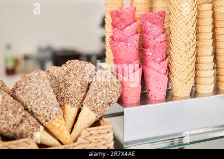 blank ice cream wafers. Waffle cones in an ice-cream shop, Italy. A variety of sugar-free vegan ice cream with natural ingredients on display at the Stock Photo
