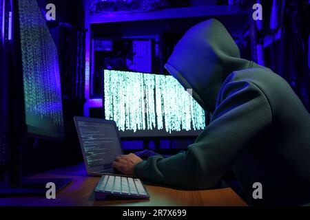 Hacker working with computers in dark room. Cyber attack Stock Photo