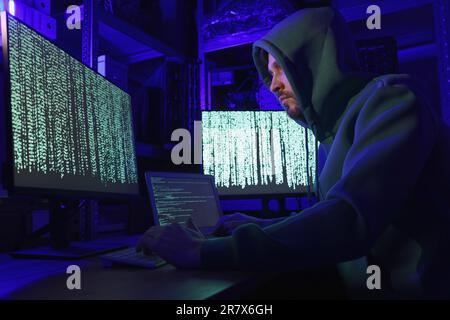 Hacker working with computers in dark room. Cyber attack Stock Photo
