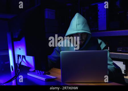Hacker working with computers in dark room. Cyber attack Stock Photo