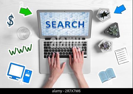 Search engine optimization (SEO). Copywriter working on laptop at wooden table, top view. Plants and virtual icons around her Stock Photo