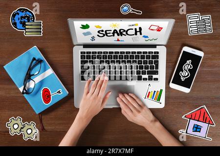 Search engine optimization (SEO). Marketing specialist using laptop at wooden table, top view. Virtual icons around her Stock Photo