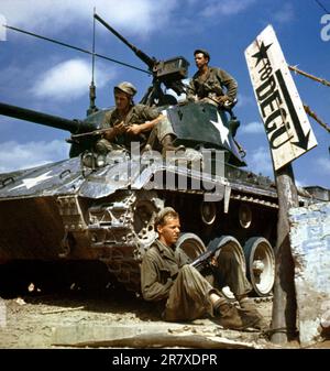 Members of this tank crew on the Korean front have painted the features ...