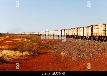 Empty iron ore railway carriages returning to mine site, Pilbara, Western Australia Stock Photo