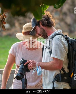 Galle, Sri Lanka - 02 15 2022: Male photographer showing photos to his girlfriend on tour in the tropics. Stock Photo